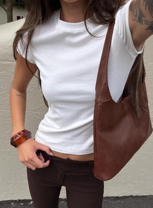 woman wearing white tee with cowgirl boots